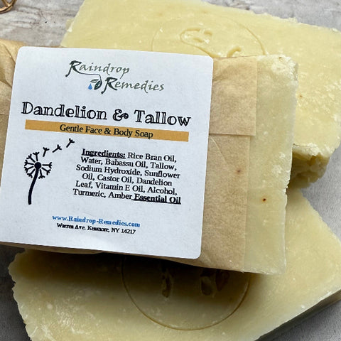 Three bars of soap with a label on a textured surface